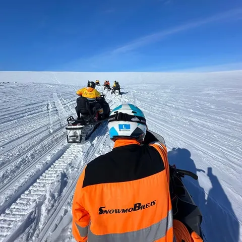 Snowmobiles lined up on the glacier