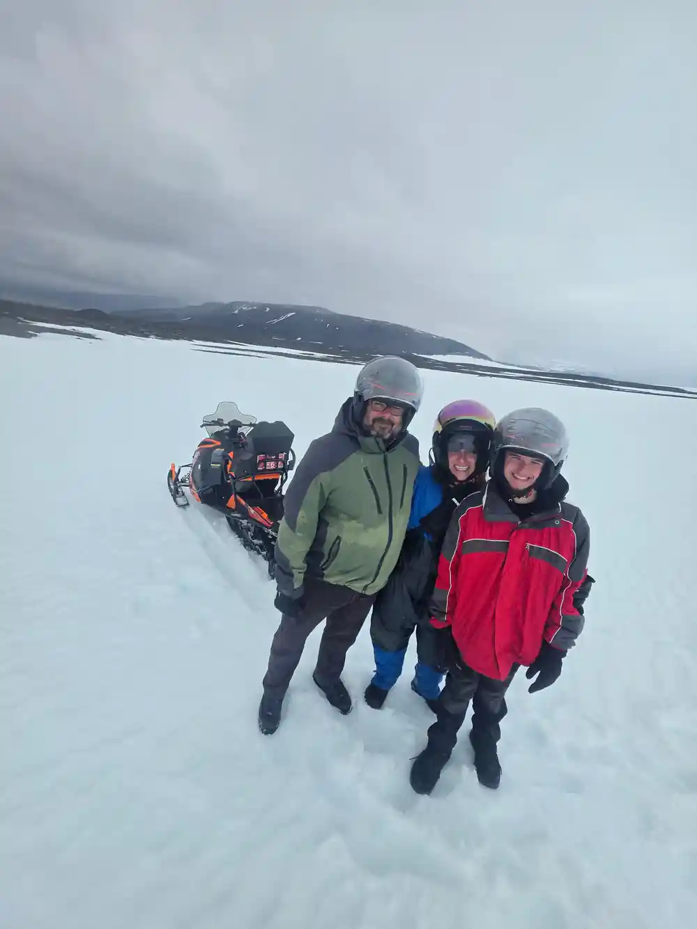 Group of four people in winter gear on snow